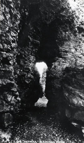 Postcard photograph entitled The Keyhole, Blackhall Rocks, showing a close-up of the view through the keyhole; the photograph shows only the detail of the rocks, and the shape of the hole in the rock, which gives it the name of keyhole
