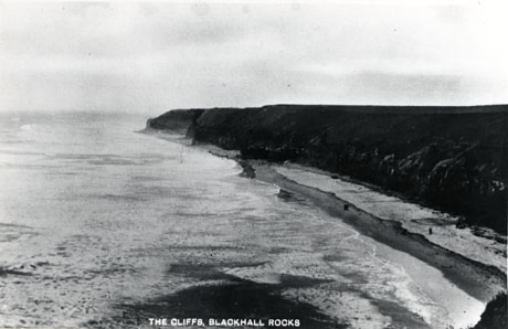 Postcard photograph, entitled The Cliffs, Blackhall Rocks, taken from the air, looking south, showing the line of the cliffs, the beach ,and the sea.