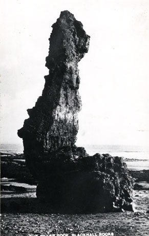 Postcard photograph entitled The Pillar Rock, Blackhall Rocks, showing the pillar rock, a piece of rock standing on its own, close up, looking towards the sea.