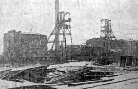 Photograph showing an indistinct picture of a the winding house, two winding gear and two other buildings of a colliery; it has been identified as Blackhall Colliery