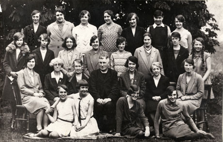 Photograph of twenty five members of Castle Eden Girls' Friendly Society taken with a clergyman; on the back row, first from the left is Mrs. Healer; second from the left Miss Guite; fourth from the left Miss McEndo; Fifth from the left Miss McEndo; on the front row, first from the left, Rita Thubron, later Mrs. Harrison; second from the left Eva Sawden, later Mrs. Berry