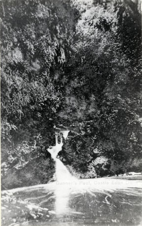 Postcard photograph entitled Gunner's Pool, Castle Eden, showing a small fall of water running into a pool from the side of a hill obscured by trees