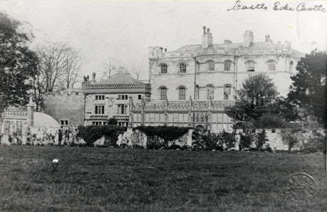 Photograph of the exterior of The Castle, Castle Eden, taken close to the castle, so that the details of the architecture may be seen; the facade of the main building, that of a smaller building attached, and what appears to be a glass house can be seen in some detail