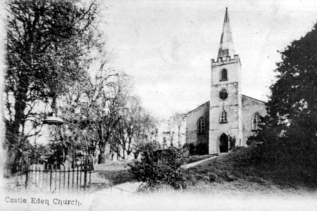 Postcard photograph entitled Castle Eden Church, showing the lych gate, churchyard, tower, spire and west end of Castle Eden Church