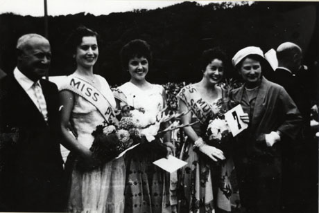 Photograph showing Emmanuel Shinwell standing with three beauty queens: Miss Simpson, Miss Crimdon ; Miss Murton and Seaton; and Miss Peterlee; the sashes worn by all three cannot be seen clearly.