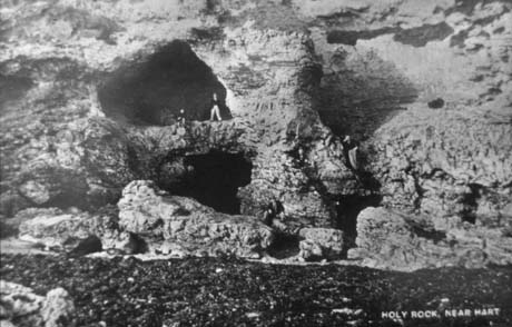 Postacrd photograph entitled Holy Rock, Near Hart, showing caves in a cliff; this is a duplicate of blac0013