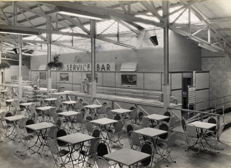 Photograph of tables and chairs, a counter with shelves for food, with a notice reading Self Service Bar behind it; the girders of the building can also be seen; the building has been identified as The Pavilion, Crimdon Dene at its official opening; the photograph was taken by T. G. Reeves, 351, London Road, Mitcham, Surrey