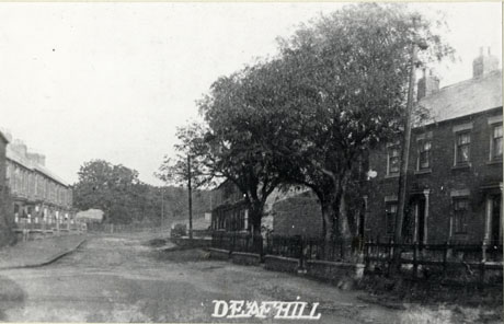 Postcard photograph entitled Deaf Hill showing a wide street with terraced houses on either side; trees and telegraph poles can be seen.