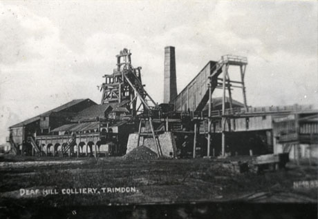 Postcard photograph entitled Deaf Hill Colliery, Trimdon showing the colliery buildings, the winding gear, and attached buildings from a further distance and slightly different angle from that in deaf0004