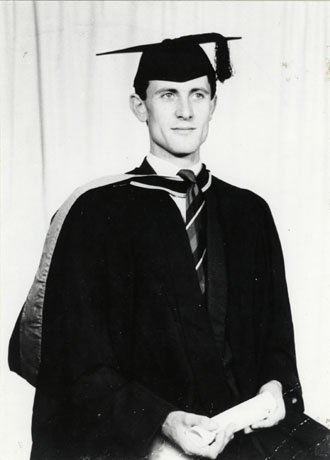 Three-quarter-length photograph of Owen Smith on his graduation, wearing a gown and mortar board; Mr. Smith, a grandson of Mr. Butterfield, was later Headmaster of Howletch and Acre Rigg School, Peterlee
