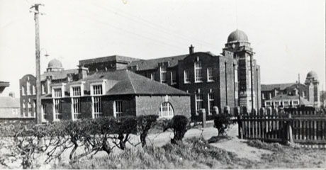 Photograph of the exterior of Easington Colliery Junior Mixed School, taken from across the road from the school and from an angle