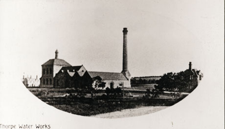 Postcard photograph entitled Thorpe Water Works, showing the exterior of the water works in the middle distance; the photograph is fairly indistinct