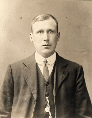 Photograph of the head and torso of William Sutherland, of Easington Colliery, at the age of 24; he is wearing a stiff collar and tie, a jacket and waistcoat, with watch chain