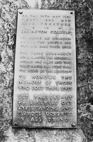 Photograph of a plaque set into a stone erected in memory of the eighty one miners who died in an explosion at Easington Colliery on 29 May 1951 and in memory of the two miners who died in attempting to rescue the victims; the names of the individual miners are not listed