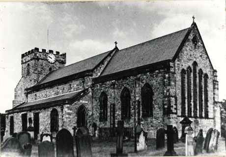Photograph of the exterior of St. Mary's church, Easington, taken from the south east from a spot in the churchyard; some gravestones can be seen in the foreground of the photograph