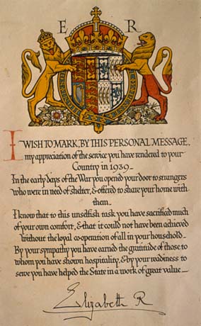 Photograph of a document, bearing the signature of Queen Elizabeth II and bearing her coat of arms, thanking the unidentified addressee for taking strangers into his or her home in 1939 in order to assist the War Effort, presumably a reference to the reception of evacuees at the beginning of the Second World War