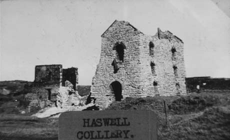 Photograph with a typed note, as follows: Haswell Colliery, showing two ruined brick buildings; one has six windows on its side and two large openings on its end; the other consists only of two walls This photograph was submitted by Philip Soakell from the album 'History of Haswell and District', which was compiled by his grandfather Fred Soakell.