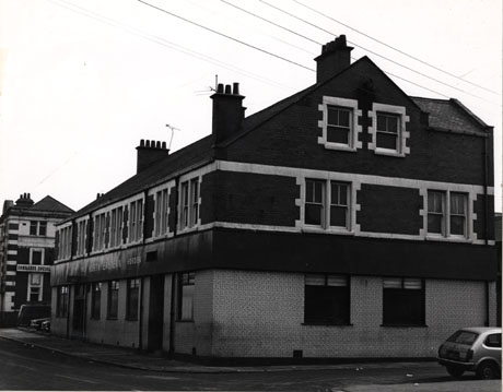 Photograph of the exterior of the side and front of The North Eastern Hotel, Horden; beyond the hotel, part of the exterior of the Comrades' Social Club can be seen; part of the rear of a car can be seen on the right of the picture