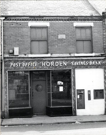 Photograph of the facade of Horden Post Office and Savings Bank; above the facade of the post office there is a stone in the wall of the building reading Prospect Terrace