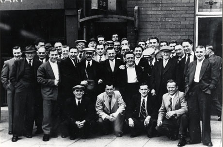 Photograph of thirty eight men posed outside a building above the entrance of which the word club can be seen; all the men are dressed in suits; the photograph has been identified as Horden Labour Club Committee and Members, 1950s