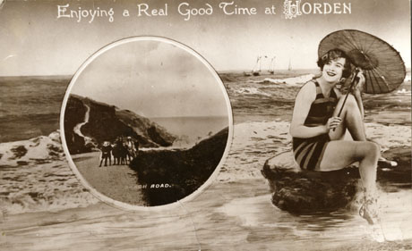 Postcard entitled Enjoying a Real Good Time at Horden, showing a woman in a bathing costume, carrying a parasol, and sitting on a rock in front of the sea; inset is a picture of Beach Road showing a road rising up a cliff with sea in the background and a group of eight children in the foreground; the inset photograph is so small that the children cannot be identified