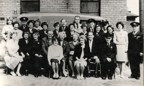 Photograph of a group of eighteen women and nine men posed in front of a Royal Mail van outside a building; five of the men are wearing uniform; the group has been identified as Post Office staff, Horden