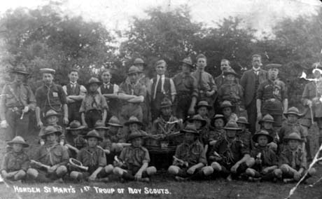 Photograph with the inscription: Horden St. Mary's 1st Troup of Boy Scouts, showing approximately twenty four boys in scout uniform, posed with two boys in the uniform of a nautical organisation, six men in scout uniform and five men in suits; they are posed in front of trees