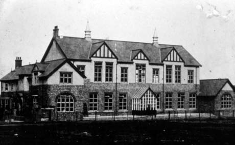 Photograph showing a large building with a porch and two wings at either end; it has been identified as the New Club, Horden; it is it is to be assumed the same building as that in 0332 before it was altered and enlarged