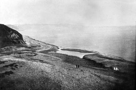 Photograph, taken from a height, showing the sea on the right of the picture, a bay of land stretching from left to right, and the shore in the centre of the photograph; the photograph has been described as Dene Holme, Horden