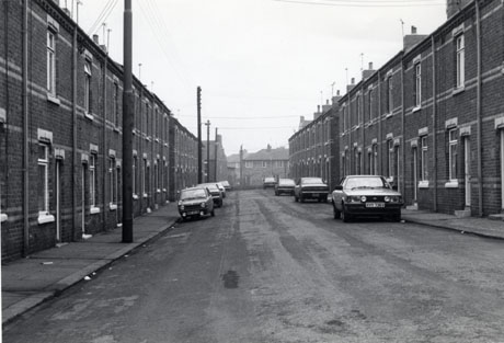 Photograph showing a street running away from the camera with terraced houses on either side; semi-detached houses can be seen at the end of the street; eight cars are parked in the street; the one nearest the camera has the registration XVY 736V; the street has been identified as being in Horden