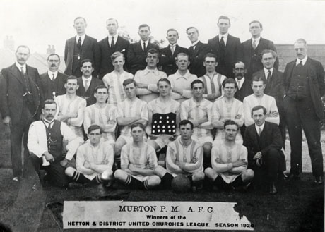 Photograph entitled Murton P[rimitive] M[ethodist] A[thletic] F[ootball] C[lub] Winners of the Hetton and District United Churches League Season 1920, showing fifteen men in the club's strip, accompanied by fifteen men, posed in the open air; a player in the middle of the group is holding a board on which sixteen medals are displayed