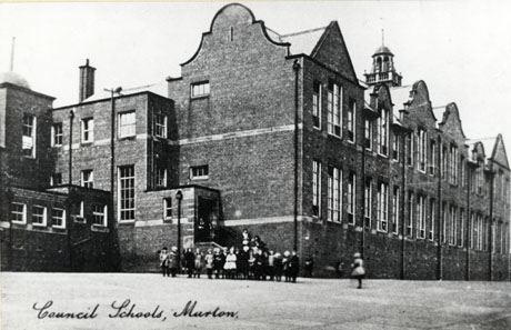 Postcard photograph entitled Council Schools, Murton, showing the front and side of the school building; a group of unidentifiable children can be seen in the playground in the middle distance;the school is a large brick building with two rows of large windows along its front