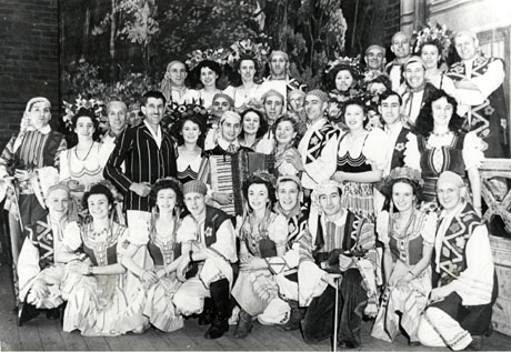 Photograph of the cast in costume of the Murton Amateur Operatic Society's production of Magyar Melody; the thirty seven members of the cast are photographed in a group in front of the scenery