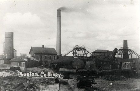 Photograph entitled Murton Colliery showing the buildings close-up, including winding gear, two chimneys and five brick buildings