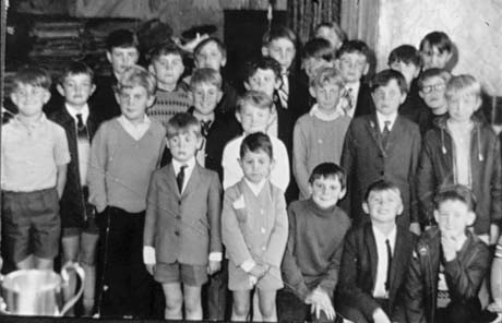 Photograph of a group of twenty three boys, aged between approximately six and ten years, standing looking towards the camera; they have been identified as attending a Road Safety Presentation of Awards in Murton; the top of a presentation cup can be seen in the left-hand corner of the photograph