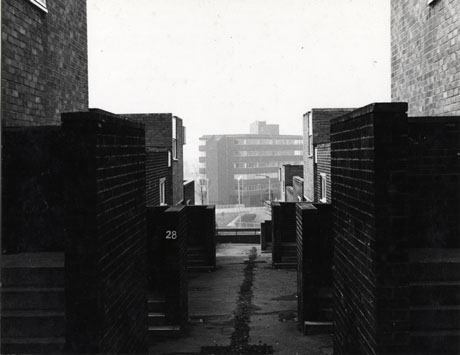 Photograph, taken between buildings, of a large block of flats or offices, in the distance; the photograph has been identified as Ridgemont House From Brandlings Court