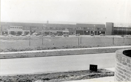 Photograph of a parade of shops, described as Shopping Centre, Peterlee with open space in front of it; the shopping centre is, it would seem, under construction