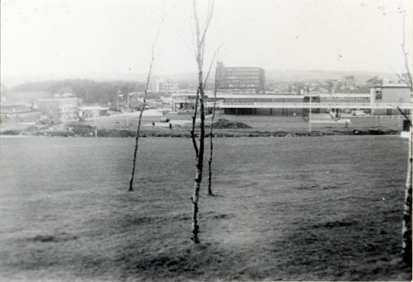 Photograph of the town centre, Peterlee, possibly under construction; in the foreground is open ground and saplings