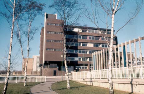 Photograph of the exterior of a brick block of six storeys with continuous lines of windows on each floor; it has been identified as Ridgemont House, Peterlee