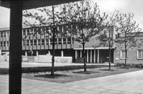 Photograph showing the exterior of a three-storey brick building with the words Magistrates' Courts over the entrance, taken from across a paved courtyard with three trees in it; they have been identified as being in Peterlee