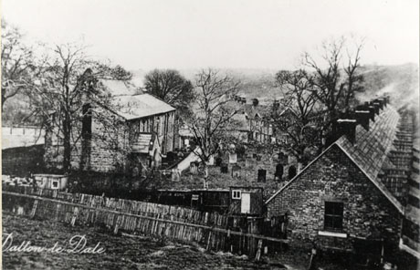 Postcard photograph entitled Dalton le Dale' showing the exterior of a church on the left; in the centre of the picture is the graveyard adjoining the church, and, on the left, the end and roofs of a row of terraced houses; beyond the graveyard in the centre of the picture further houses can be seen