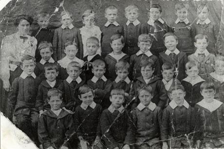 Photograph of a group of thirty three boys, aged approximately seven years, with a woman, presumably their teacher; they have been identified as pupils in Standard Two of The National School, Seaham