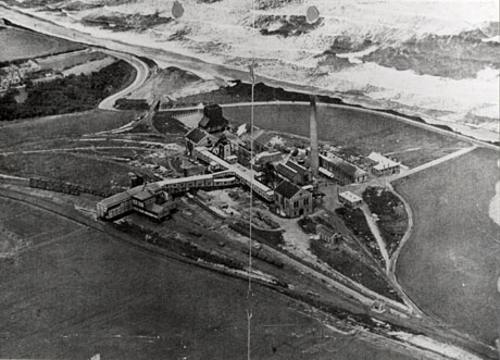 Photograph of an aerial view of the buildings of a colliery with the sea to the top right of the picture; the colliery has been identified as Vane Tempest, Seaham