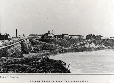 Photograph of an engraving showing a rocky coastline curving from left to right with the sea on the right of the picture; on the top of the cliffs is an imposing line of buildings with an office; on the left is a line of coal trucks; the picture has the caption Seaham Harbour, From The Lighthouse and the words Cook and Co., London