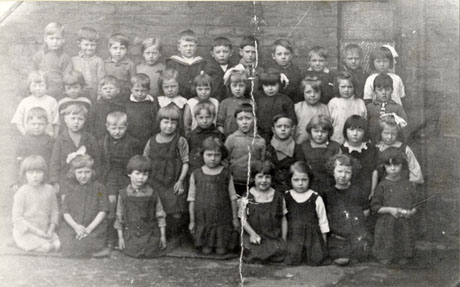 Photograph of forty children, aged approximately seven years, grouped against a brick wall; they have been identified as children from the Church of England School, Seaham Harbour