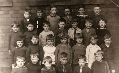 Photograph of the head and shoulders of twenty seven boys aged approximately seven years posed in front of a wall; they have been described as pupils at the Junior School, Shotton, 1926