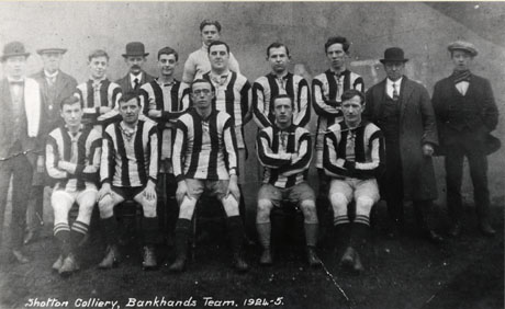 Postcard photograph entitled Shotton Colliery, Bankhands Team, 1924-5, showing eleven men in football strip accompanied by four men in suits and hats