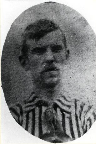 Photograph of the head and shoulders of a man with a moustache wearing a striped shirt with a collar; the photograph is indistinct but the man has been identified as Tom Tremelyn, a footballer of South Hetton