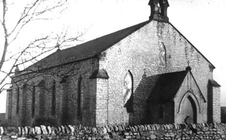 Photograph of the exterior of a church showing the north side of the west porch and the north side of the nave; the top of the churchyard wall can be seen at the bottom of the picture; the church has been identified as Thornley Church