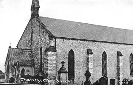 Photograph showing the exterior of a church; the south side of the porch and the south side of the nave of the church and the tops of six tombs in the graveyard can be seen; the church has been identified as Thornley Church